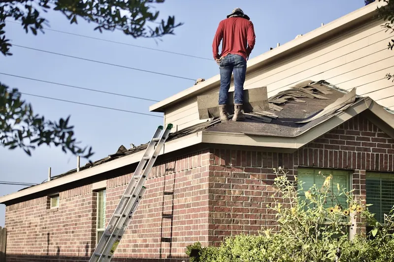 Professional roofer working on a residential roof in Downtown St. Paul